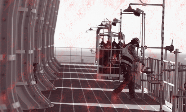 A worker at a carbon capture facility in West Texas (Photo: Getty Images; additional design The Spinoff) 
