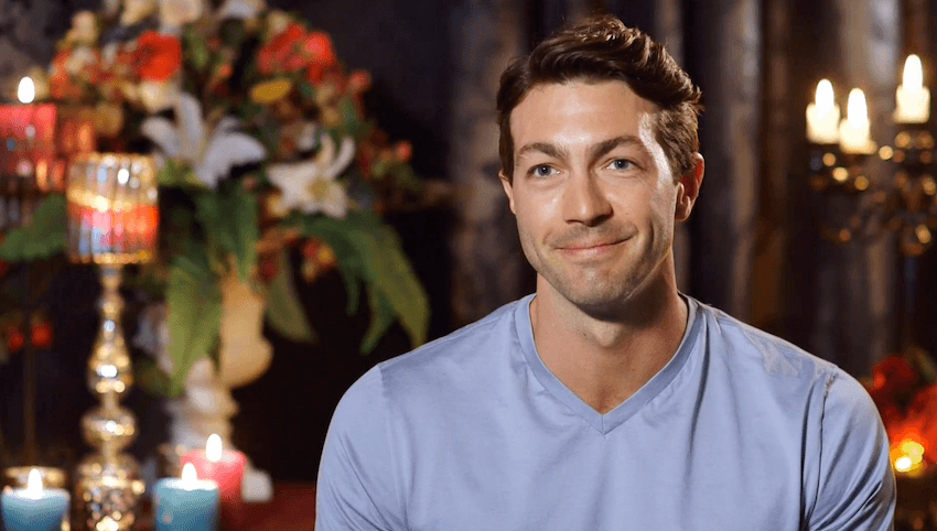Art Green smiles at the camera surrounded by candles