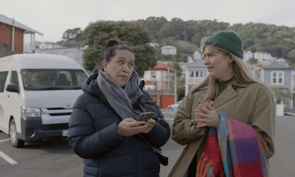 kura and brynley standing in wellington car park under overcast skies