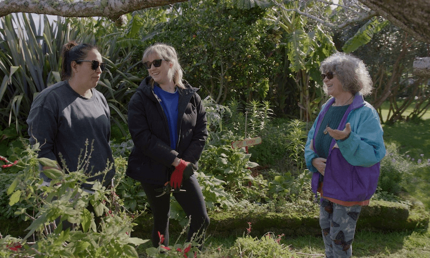bryn and ku chat to an older woman in a garden