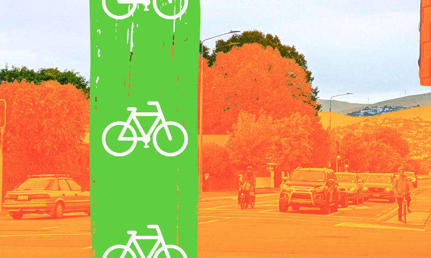 a photo of some cars and cyclists at a traffic light with a green strive of paint showing simplified bike icons like cycle lanes have