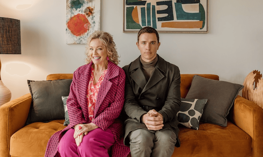 a woman (Rebecca Gibney) and man (Harry McNaughton) sit awkwardly on an orange couch