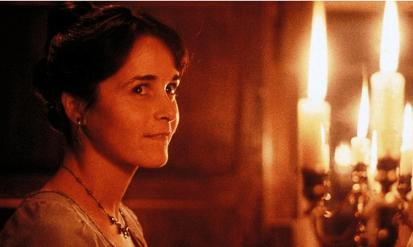 Amanda Root as Anne Elliot. It is a close up of Anne in a room lit by candles.