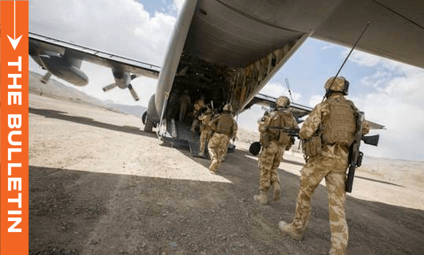 Soldiers in camouflage uniforms and gear board a military transport aircraft on a sandy landscape under a partly cloudy sky. An orange vertical banner on the left reads "THE BULLETIN.