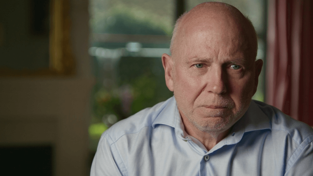 bald man with unhappy facial expression