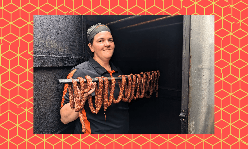 a woman with a smile holds a long string of sausages