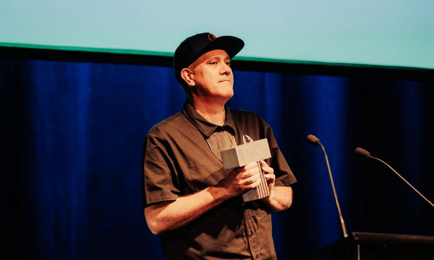 Mokotron accepts his Taite award on stage.