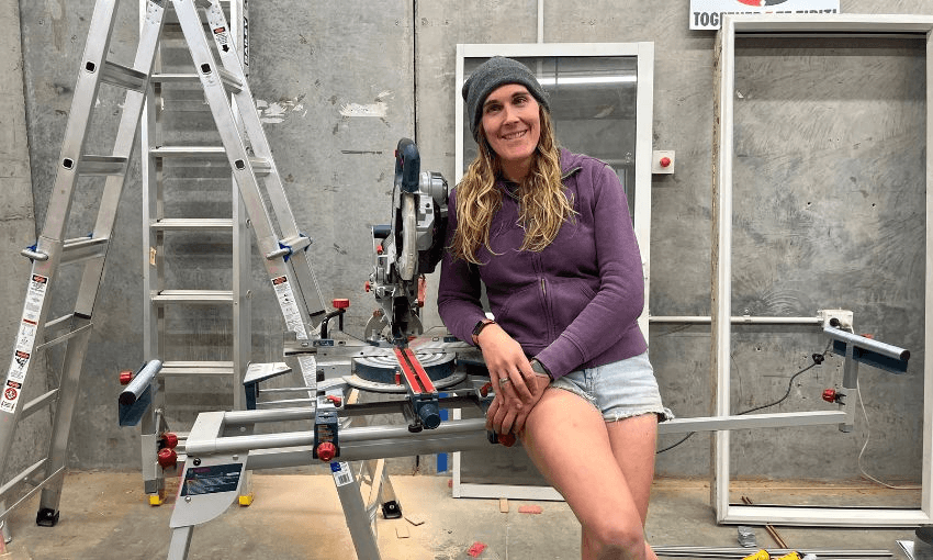Cahoots' Jade Musther leans against a table saw in her workshop.