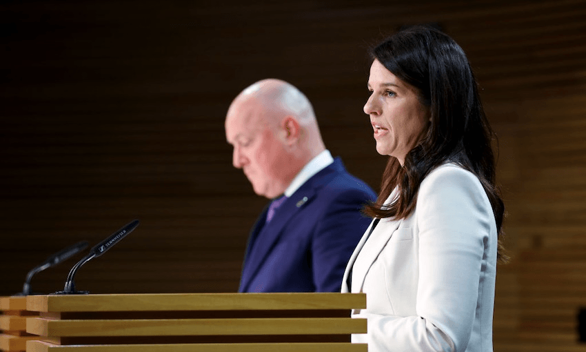 Chris Luxon and Erica Stanford speak ahead of the Royal Commission of Inquiry final report release in 2024 (Photo by Hagen Hopkins/Getty Images) 
