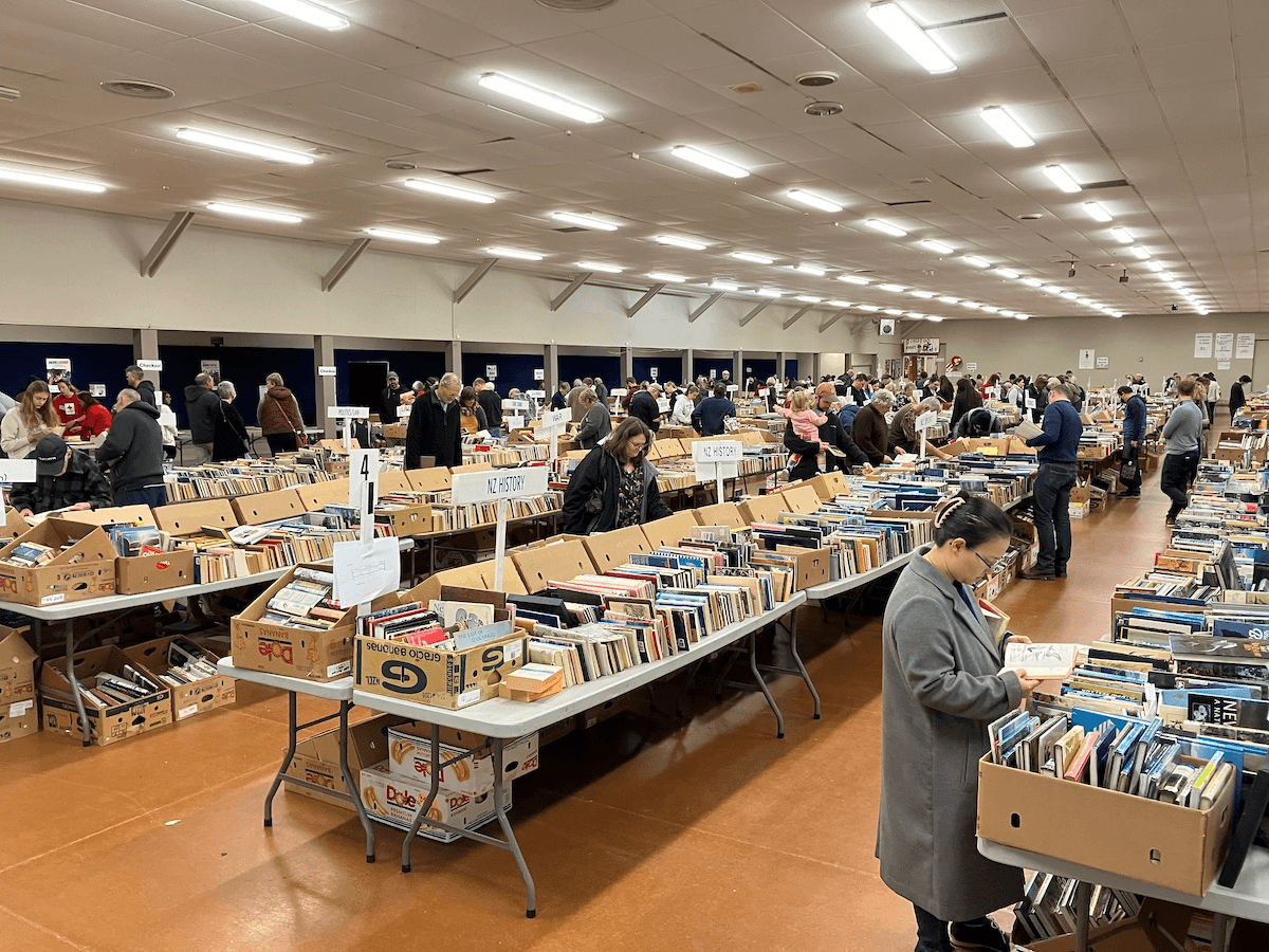people browsing secondhand books on long tables