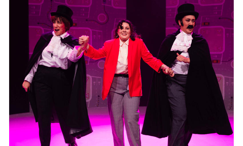 A photograph of one woman in a red jacket flanked by two actors dressed like Dracula. 