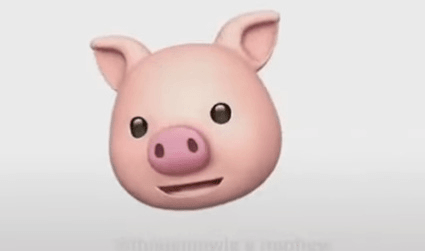 A 3D animated pink pig face with large black eyes, a round snout, and open mouth, set against a plain light gray background.