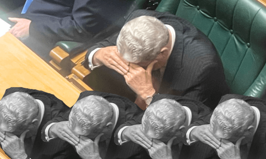 Winston Peters in a suit in parliament with head in hands
