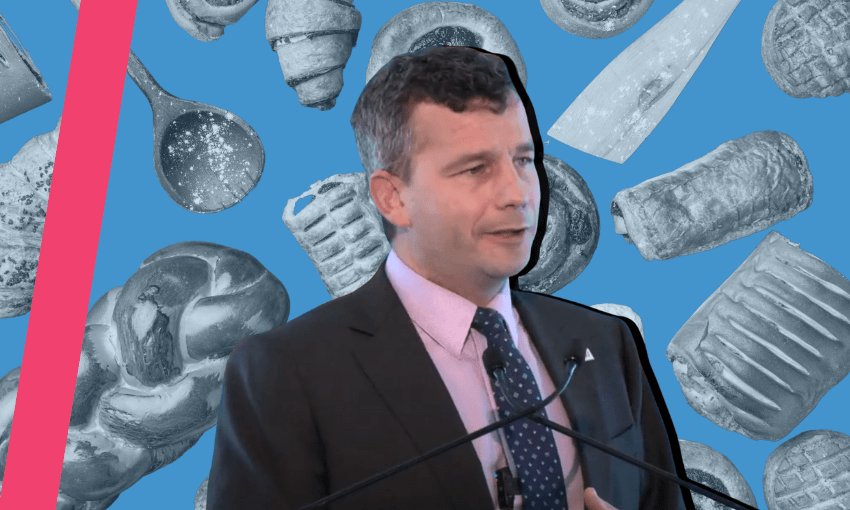 David Seymour, newly minted deputy prime minister speaking to Act Party supporters amist a sea of pastry. 
