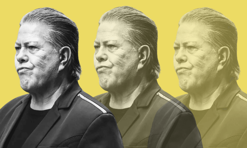 A man in a dark blazer with slicked-back hair stands against a yellow background. Two semi-transparent, faded duplicates of him appear behind, creating a layered effect.