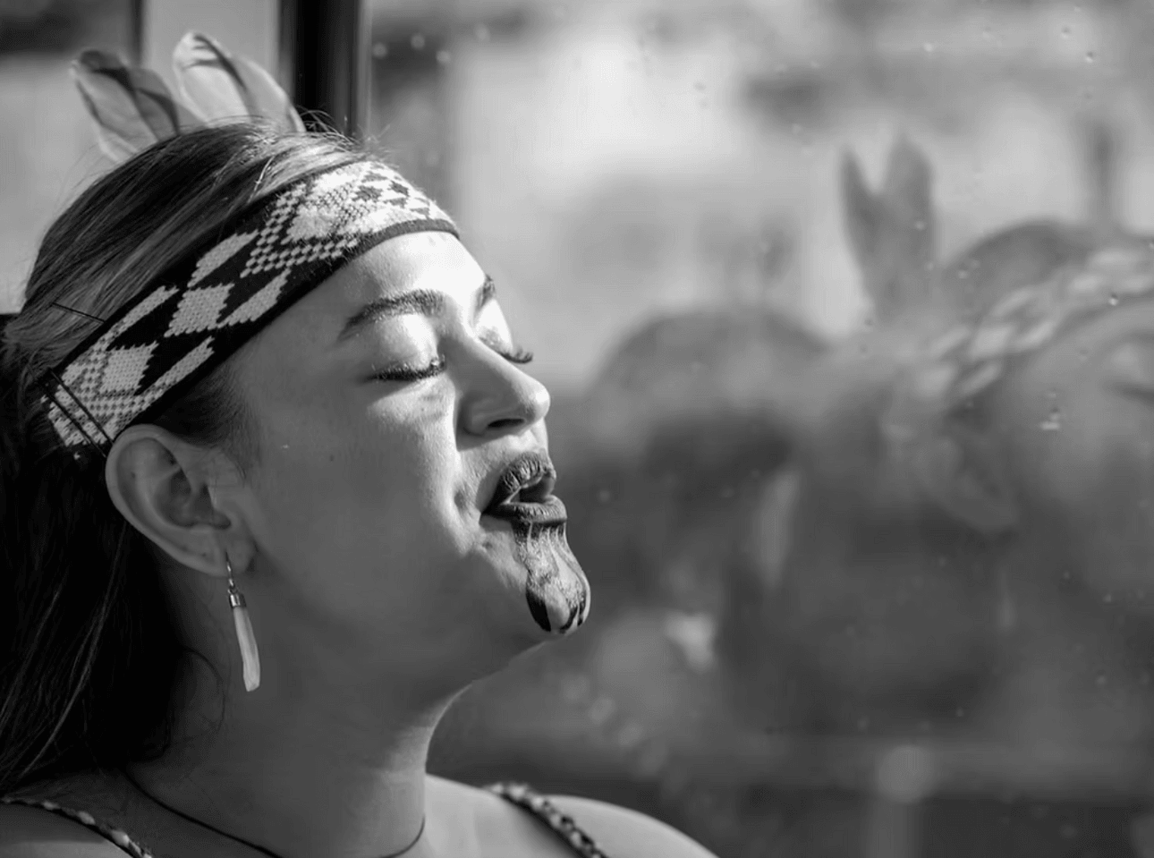 black and white photo of a woman performing kapa haka