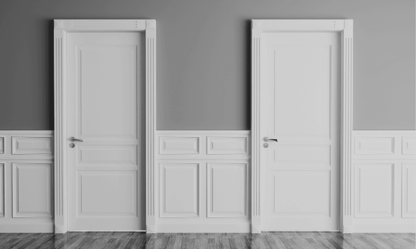 a black and white image showing two closed white office doors