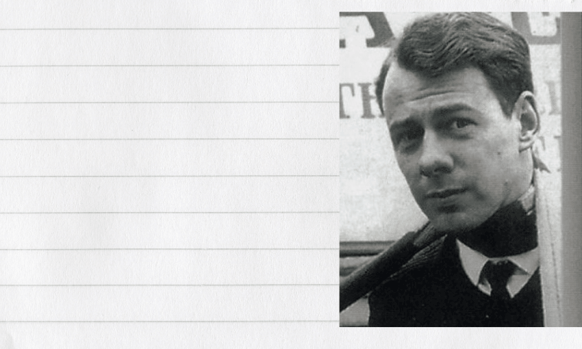 An old, black and white photo of a young man wearing a suit and tie