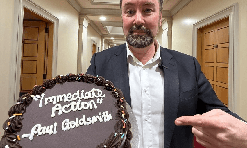 Labour's Reuben Davidson delivers a cake for Paul Goldsmith reading "immediate action".
