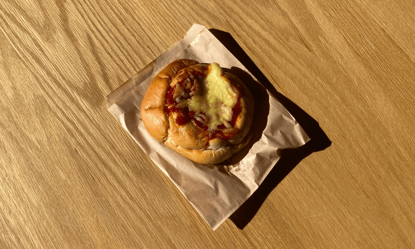 a round pizza bread on a brown bag in a wooden table