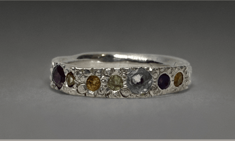 silver ring with coloured gemstones