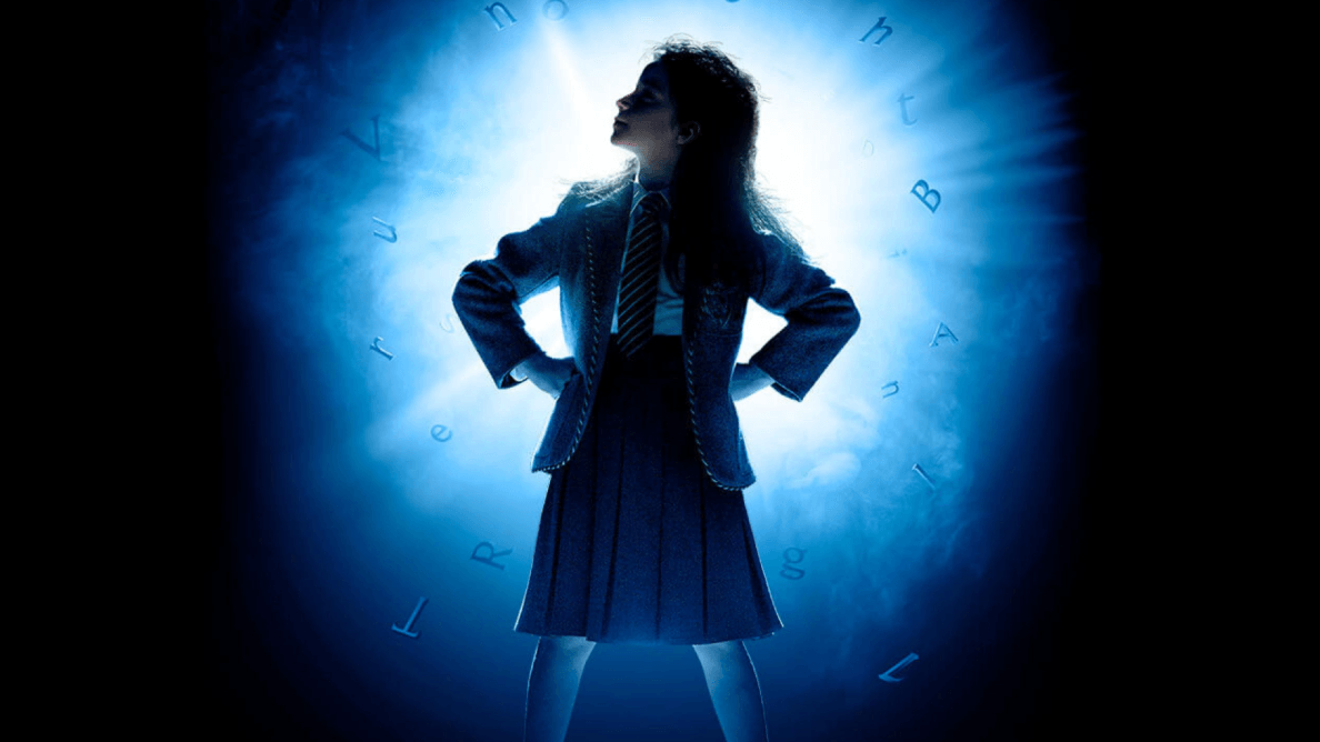 photo of a little girl in school uniform with blue light backlighitng her