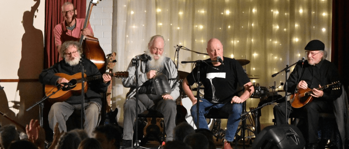 a groupd of folk musicians on stage