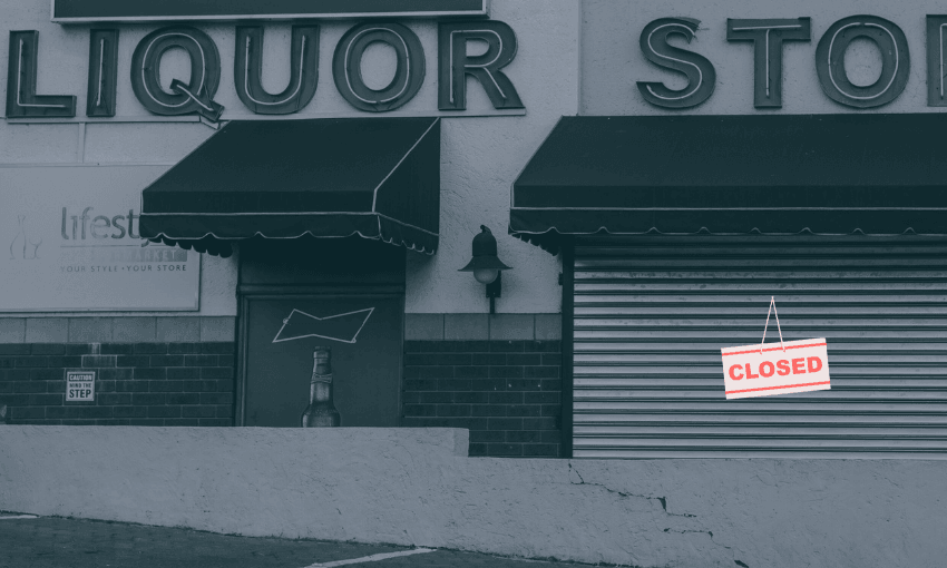 A liquor store with closed metal shutters and a "CLOSED" sign hanging on the front. The entrance and windows are covered, and the building exterior has large store signage.