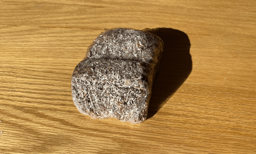 a chocolate lamington on a wooden table