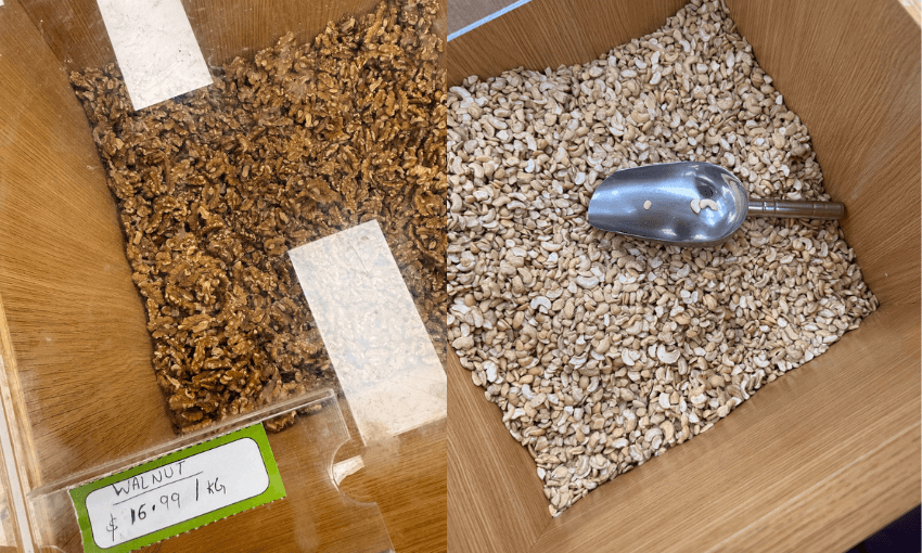 Two wooden bins filled with bulk foods: one contains chopped walnuts with a price label, the other holds cashew nuts with a metal scoop resting on top.