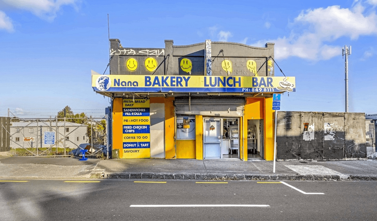 a yeallow and grey building with "Nana Bakery Lunch Bar" in blue writing along the top