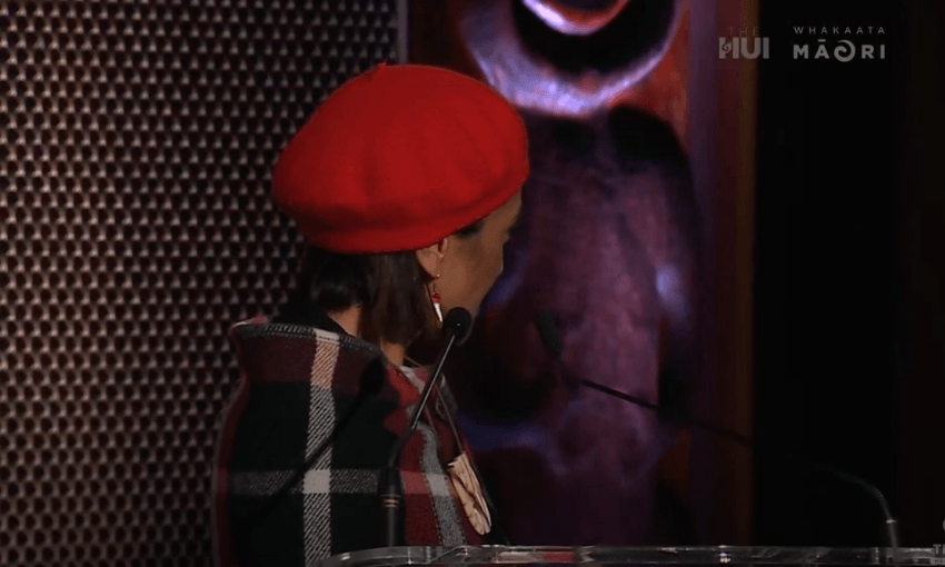 Oriini Kaipara's face is out of frame as she looks to her side to get approval from her party leaders.