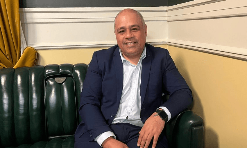 Peeni Henare smiles while sitting for a photo in Pint of Order.