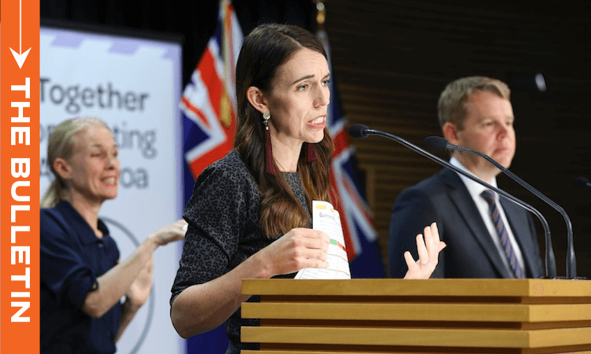 A woman speaks at a podium with New Zealand flags behind her, holding papers. A man stands beside her, and a sign language interpreter is visible in the background. A banner reads “Together fighting” with partial text visible.
