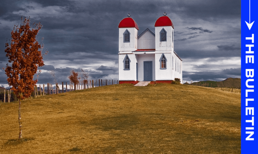 A small white church with two red domes stands on a grassy hill under a cloudy sky, with a single autumn tree nearby and a blue vertical banner on the right labeled "THE BULLETIN.