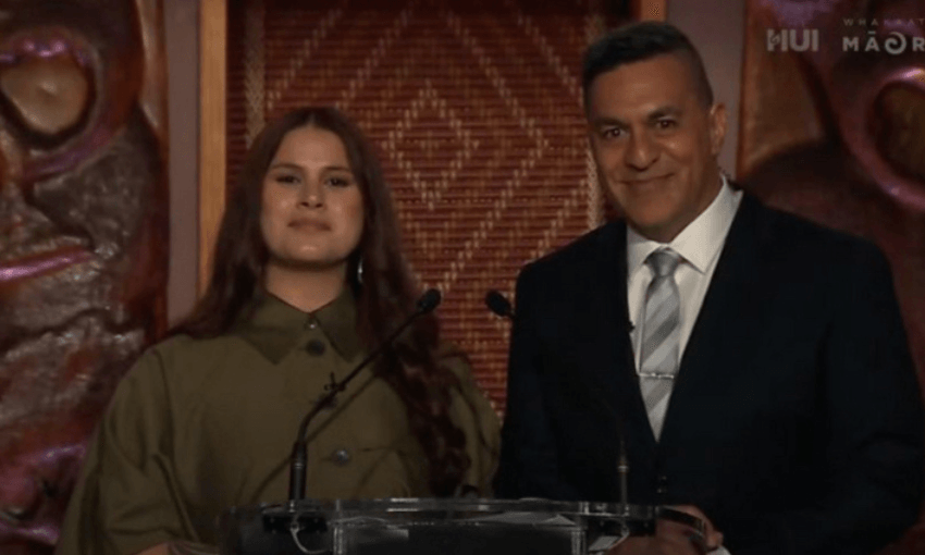 Māni Dunlop on the left in a khaki shirt and Julian Wilcox on the right in a suit and tie