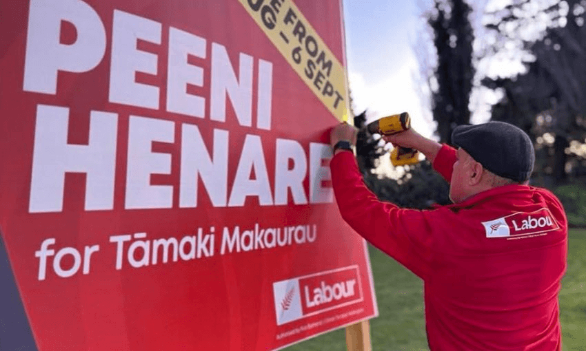 A shot of Peeni Henare putting up a billboard promoting his contest in the Taamaki Makaurau byelection.