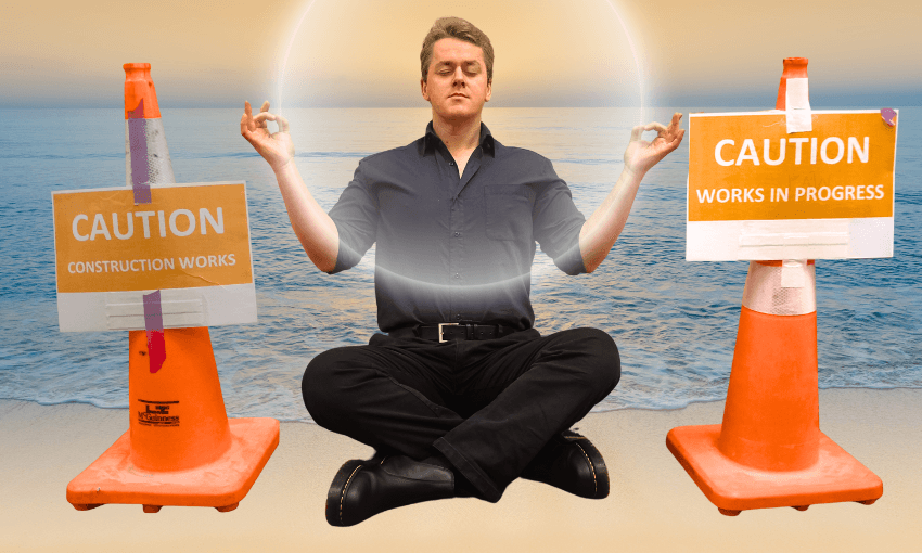 A man sits cross-legged and meditates on a beach at sunset between two orange caution cones with signs reading "CAUTION CONSTRUCTION WORKS" and "CAUTION WORKS IN PROGRESS." A glowing halo circles his head.