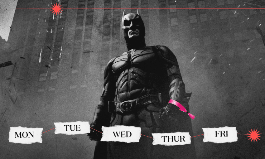 a black and white frame of batman wearing a bright pink festival wristband
