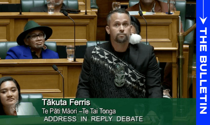 Tākuta Ferris gives his maiden speech in parliament, December 2023. Fellow Te Pāti Māori MPs Hana-Rawhiti Maipi-Clarke and the late Takutai Moana Natasha Kemp are looking on. (Image: Parliament TV) 

