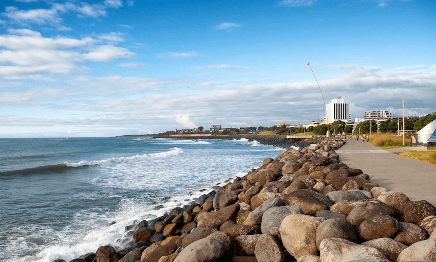 A landscape image of New Plymouth's coastal walkway, looking north, with the Len Lye Wind Wand in the distance