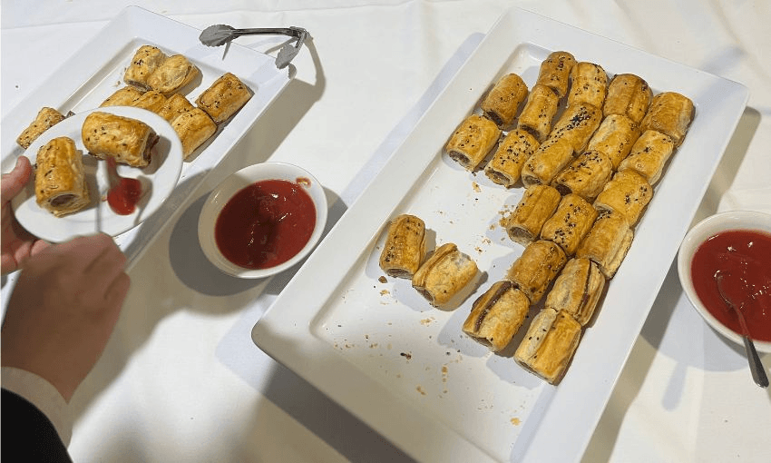A table with plates of sausages.