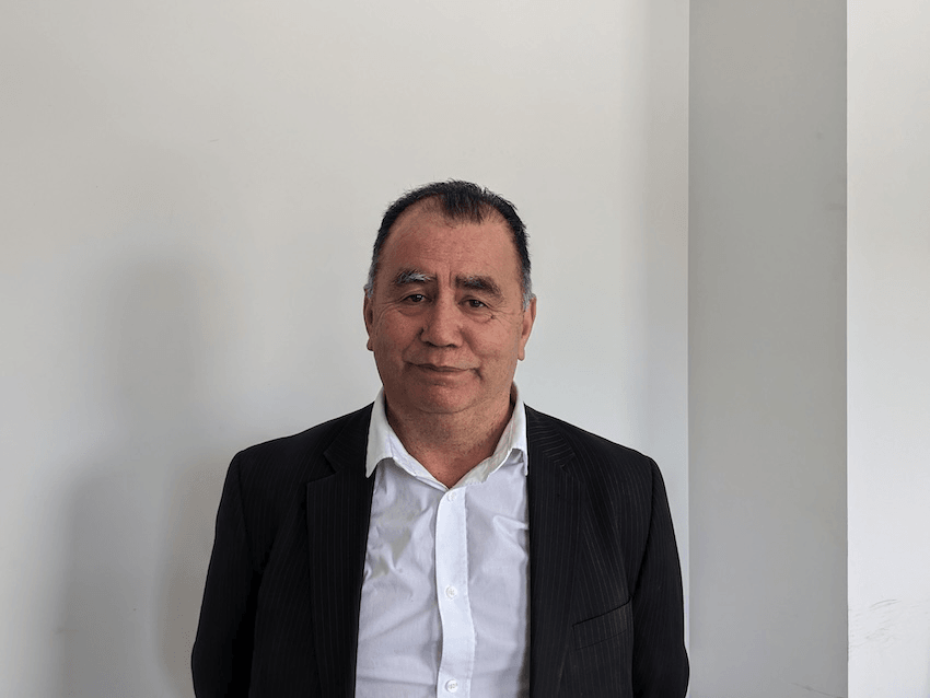 a maori man in a whit shirt with a black blazer