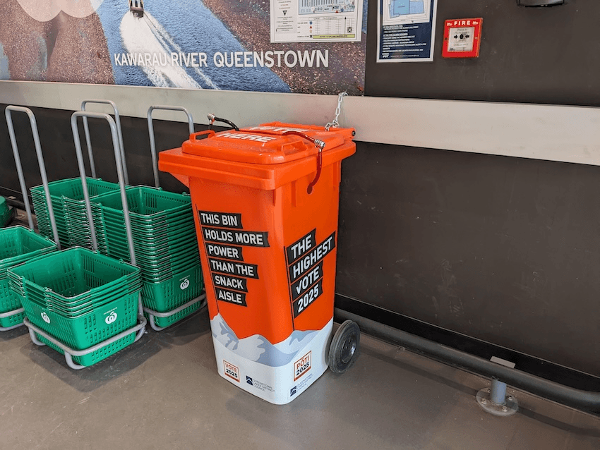 an orange bin with some shopping baskets around it and the slogan 'the highest vote'