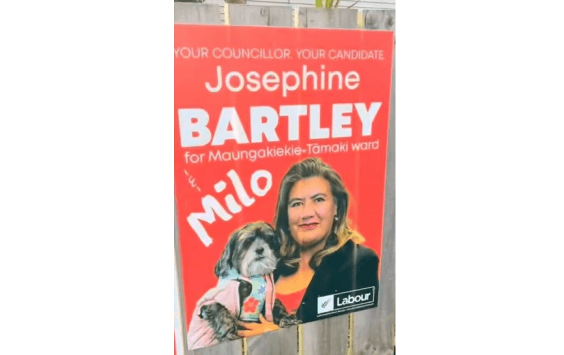 A red campaign sign features Josephine Bartley, a Labour candidate for Maungakiekie-Tamaki ward, holding a small dog named Milo. Both are looking at the camera, and the sign includes the Labour Party logo.
