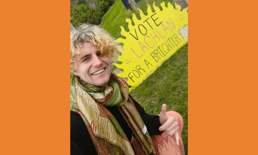 a joung person in a big scarf throwing a shaka in front of a 'vote lachlan' sign