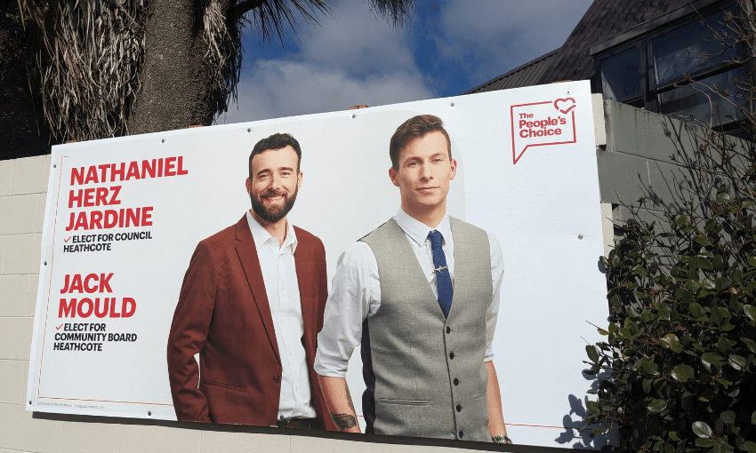 a hoarding with a picture of Nate herze, dark, bearded, jacket, and jack Mould, a community board candidate wearing a grey vest, with people's choice branding