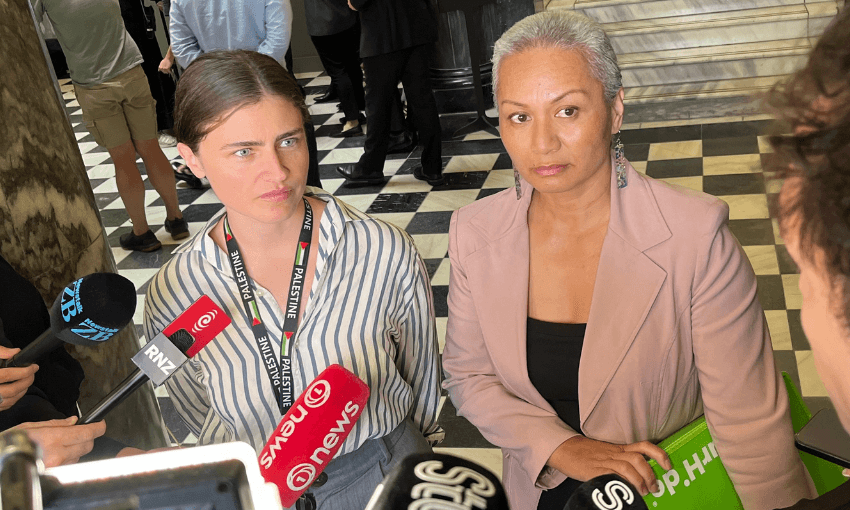 Chloe Swarbrick and Marama Davidson of the Greens speak to reporters on the tiles of the parliament building.