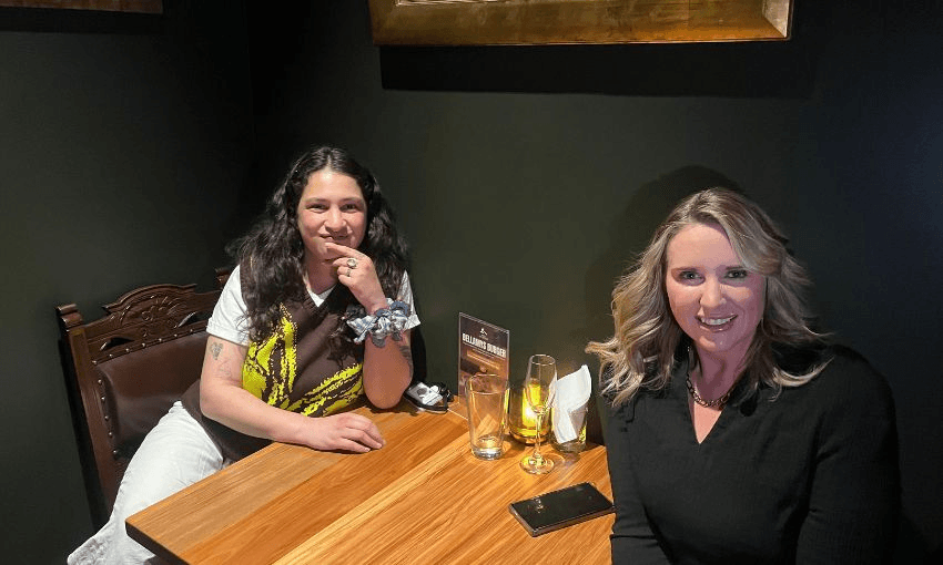 Two women sit at a bar table, at the left is the author of this piece, and on the right is politician Laura McClure.