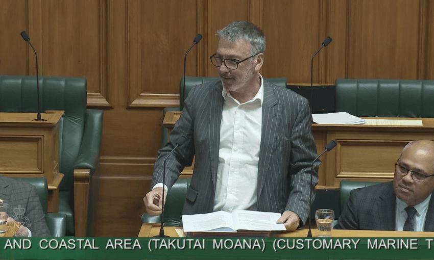 Wearing a grey suit, Labour MP Duncan Webb speaks to the House from his bench.